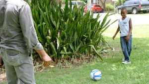 Father and son playing soccer